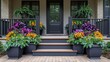 © dewi - Colorful porch planters with dark gray steps and front door