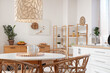 © Pixel-Shot - Dining table, chest of drawers, chairs and lamp in stylish kitchen