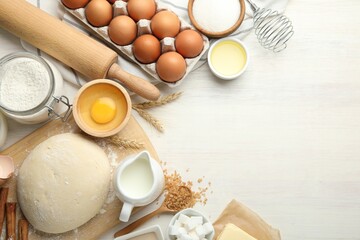 Wall Mural - Rolling pin and different ingredients on light wooden table, flat lay. Space for text