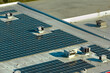 © bilanol - Photovoltaic solar panels mounted on industrial building roof for producing green ecological electricity. Production of sustainable energy concept