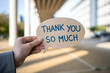 © PulseImages - Hand holding a speech bubble with thank you so much message in an outdoor setting, expressing gratitude and appreciation