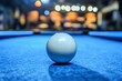 © Aldrian - Cue ball on pool table, bar background. Stock image
