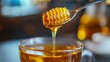 © Muekdum Studio - Liquid Gold: A macro shot reveals the pure, viscous honey cascading from a honey dipper, with a full glass teacup and the suggestion of a warm drink, this image oozes sweetness and delight.