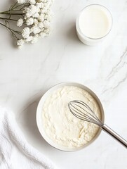 Aufkleber - Creamy mixture prepared with a whisk in a bowl alongside fresh milk and flowers on a marble countertop. Generative AI