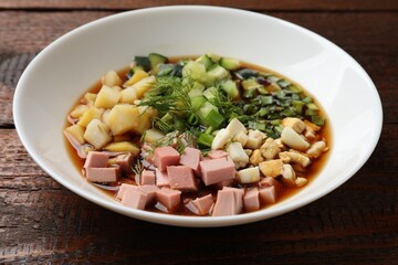 Poster - Tasty okroshka soup with kvass in bowl on wooden table, closeup