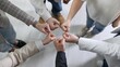 © New Africa - Unity concept. People holding fists together indoors, top view