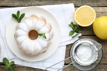 Poster - Tasty lemon cake with powdered sugar, fresh fruits and mint on wooden table, flat lay