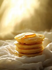 Aufkleber - Delicious golden pancakes stacked high with syrup shining in warm light on a soft cloth. Generative AI
