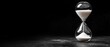 © Duskcraft - Elegant hourglass with white sand on dark surface evoking time passing and future planning in monochrome style