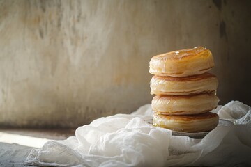 Aufkleber - Stack of fluffy pancakes drizzled with syrup on a textured surface with soft natural light. Generative AI