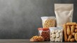 © Jakrapan - A variety of healthy snacks, including nuts and grains, displayed in jars and bags against a textured background.