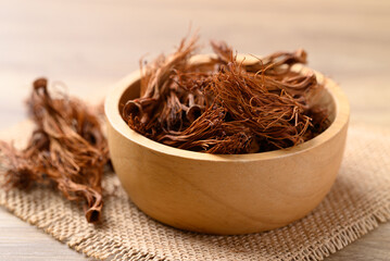 Wall Mural - Dried Bombax ceiba flower stamen (red cotton flower) in wooden bowl, Food ingredient in Northern Thai food