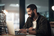 © N F/peopleimages.com - Design, laptop and programming with happy man in office at night for coding or computer engineering. Creative, research and smile with employee or programmer in workplace for project deadline