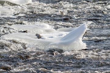 a body of water with ice floating on top