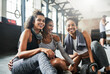 © peopleimages.com - Happy women, friends and laugh with break at gym for fun exercise, workout or fitness together. Female people, active group or team with smile for rest, recovery or funny humor at indoor health club