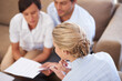 © DL/peopleimages.com - Financial advisor, meeting and couple with documents in home to purchase house, property and mortgage loan. Insurance, marriage and man and woman with paperwork for contract, investment or consulting