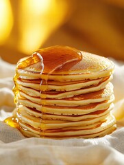 Aufkleber - Stack of fluffy pancakes drizzled with syrup resting on a soft cloth in warm sunlight. Generative AI