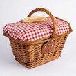 © Thananya - Brown Wicker Picnic Basket with Red and White Checkered Cloth