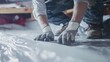 © TensorSpark - Close-up of worker's hands installing a vapor barrier, symbolizing protection and insulation.