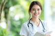 © Tondone - smiling nurse in white uniform holds notebook, showcasing warm and professional demeanor in lush, green environment
