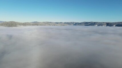 Wall Mural - Aerial winter view of Batak Reservoir covered with clouds, Pazardzhik Region, Bulgaria