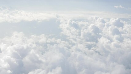Wall Mural - blue sky with white fluffy clouds from airplane flight fly over the clouds in a sunny day with cloud moving in summer time cloudscape background