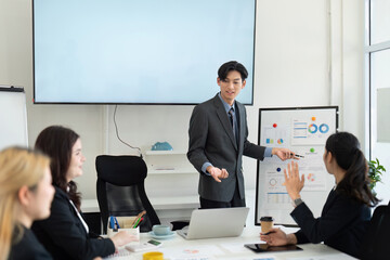 Wall Mural - dynamic business presentation with a diverse team discussing financial strategies in a modern office