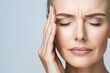 © michnik101 - Young woman touching her temple with eyes closed, expressing pain and stress. Headache and fatigue