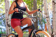 © Nobilior - woman riding a bicycle in the park. Healthy lifestyle.