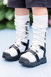 © IndigoElf - Child legs with leg orthosis. Child wearing special support shoes for rehabilitation or therapy to correct flat feet