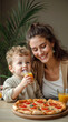 © lina - smiling mother and toddler son sharing pizza and juice