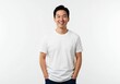 © PP Creative - A smiling man wearing a plain white t-shirt with hands in pockets isolated on a white background