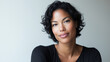 © Leo - Radiant African American woman exudes joy, embodying confidence and warmth in a serene moment.