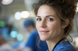 © Dejana - Portrait of smiling female doctor wearing scrubs in hospital operating room
