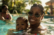 © DEIB Visuals - Happy African American mother and toddler swimming in a pool on vacation in Thailand. Smiling black mum and baby learning to swim