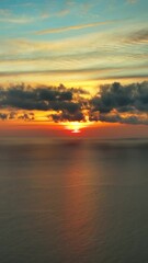 Wall Mural - aerial view of sea surface during a beautiful colourful sunset. vertical video