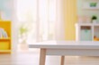 © zetrum - Close-up of a child's white table with wooden legs in a brightly lit room. Playful, inviting scene