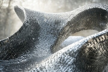 Aufkleber - Abstract silver mosaic sculpture with flowing, wave-like forms creating a dynamic visual.