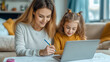 © Irina - Mother and daughter communicate in a cozy house, working on a laptop and drawing together
