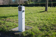 © ADDICTIVE STOCK - Electric car charging station in a lush green park setting