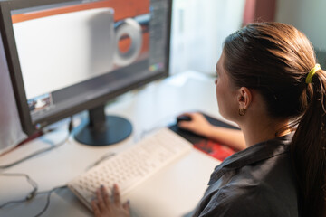 a young woman is sitting at a computer in the office