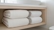 © KIMEHIME - Bathroom towels neatly stacked on shelf