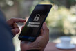 © THAWEERAT - Cyber security concept. Hand holding a smartphone to login username password on screen. Data privacy online protection on mobile phone application with 2FA increases security. Secure internet access.