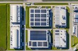 © Anamarija - Top view of a modern industrial data center or multiple buildings covered in solar panels