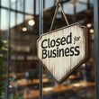 © MDAFSHAR - Closed for business sign hanging on the glass door of a cafe
