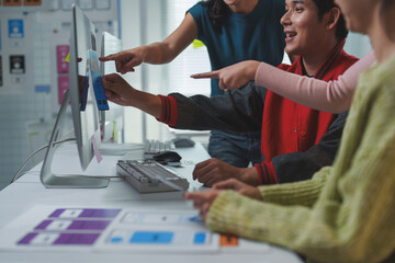 Wall Mural - web designers collaborating on color palettes for a new website interface, discussing ideas and opti