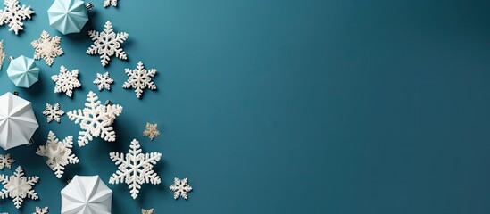 Poster - Decorative snowflakes and paper stars in white, teal, and gold arranged in a festive layout on a deep teal background for Christmas celebrations.