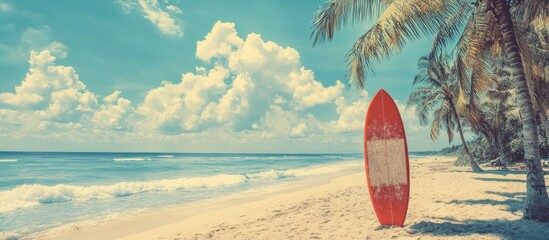 Aufkleber - Vibrant tropical beach scene featuring a red surfboard on golden sand with palm trees, turquoise water, and fluffy clouds under a bright sky.