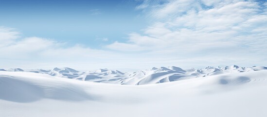 Aufkleber - Sunlit winter landscape with pristine white snow and soft blue sky highlighting delicate textures of undulating snowdrifts and distant mountain peaks