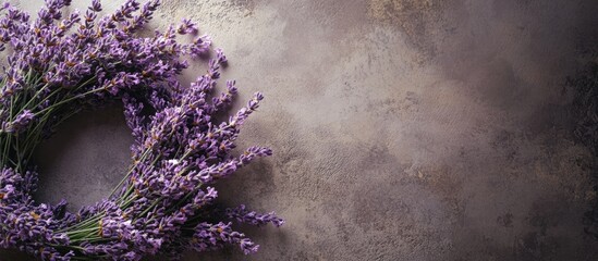 Poster - Lavender wreath beautifully arranged on the left side against a textured neutral background, emphasizing the delicate purple hues of the flowers